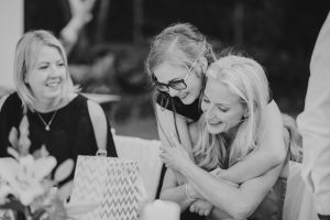 Bride's sister hugging the bride